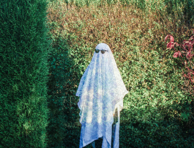 Boo Bash - student dressed as ghost with sheet and sunglasses on